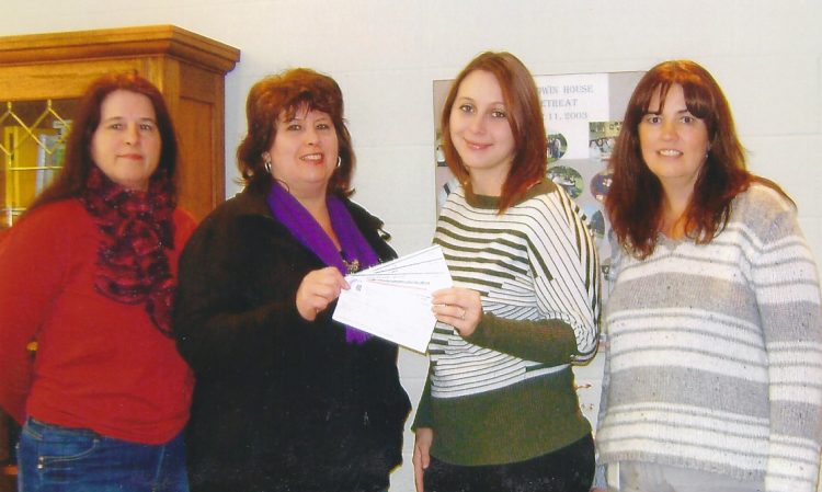 Naomi Lamarche and her Girls' Night Out team presenting a cheque to Baldwin House