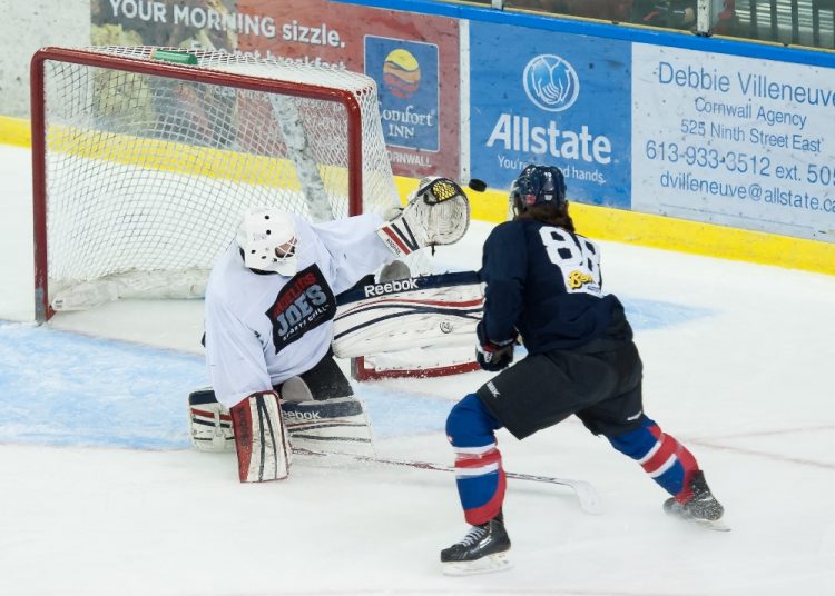 Pete Karvouniaris stops Antony Courcelles during last weekend's Intrasquad game at the Civic Complex.