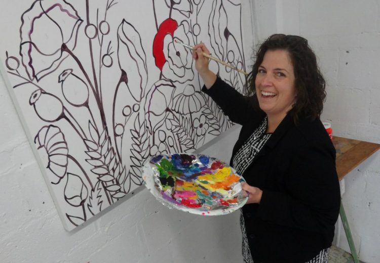 Stephanie Gibson, of McDonad Duncan, adds a splash of colour to an art canvas being unveiled for public painting this Thursday as part of #momstheword.