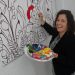 Stephanie Gibson, of McDonad Duncan, adds a splash of colour to an art canvas being unveiled for public painting this Thursday as part of #momstheword.