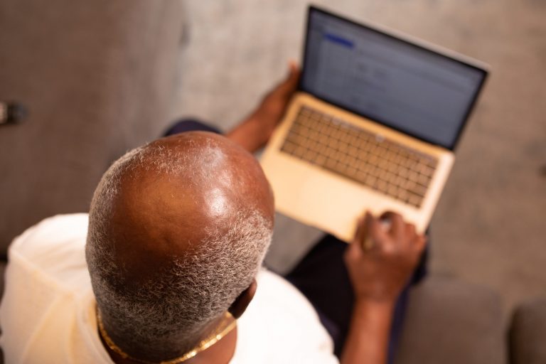 man-in-white-shirt-using-macbook-pro-3584086
