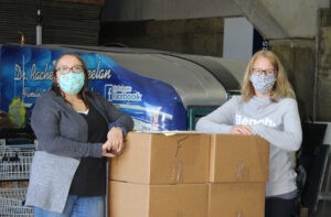 #2 Carilyne and Kimberly with a skid of carton food hampers 3