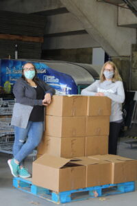 Carilyne-and-Kimberly-with-a-skid-of-carton-food-hampers-3