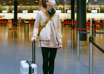 woman wearing face mask at airport
