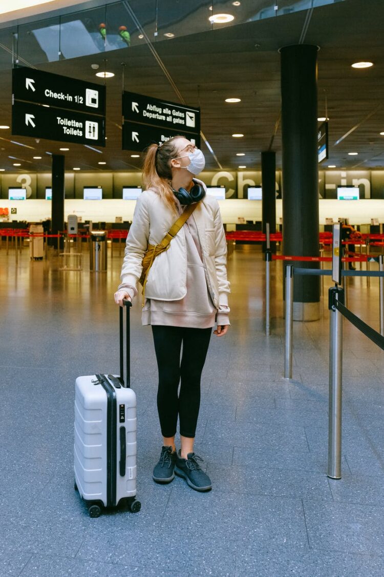 woman wearing face mask at airport