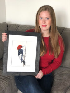 Olivia Wright of Brinston donated her watercolour painting of a Redheaded Woodpecker to help SNC raise funds for tree planting