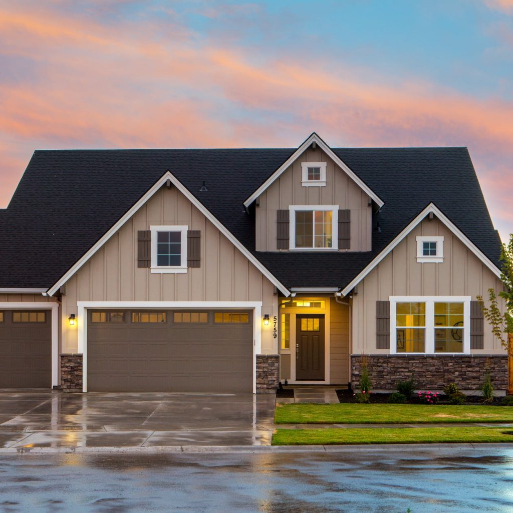 brown and gray painted house in front of road