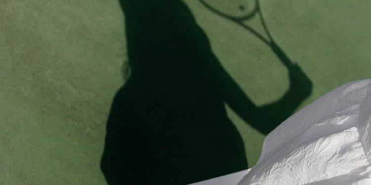 shadow of woman playing tennis