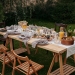 food on brown wooden table with chairs and plates
