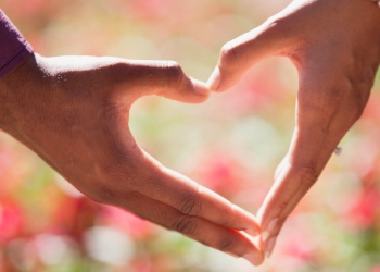 heart hand on shallow focus lens
