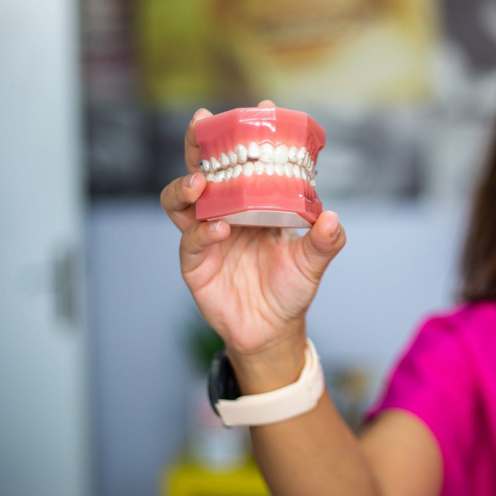 person holding red heart shaped ornament
