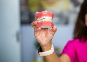 person holding red heart shaped ornament