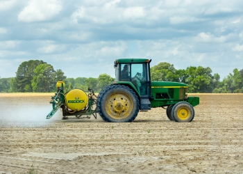 green and yellow tractor on dirt