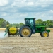 green and yellow tractor on dirt
