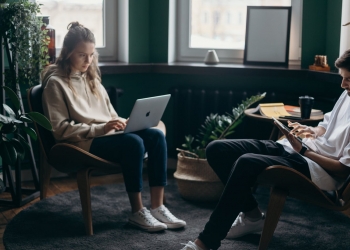 photo of two people using their gadgets