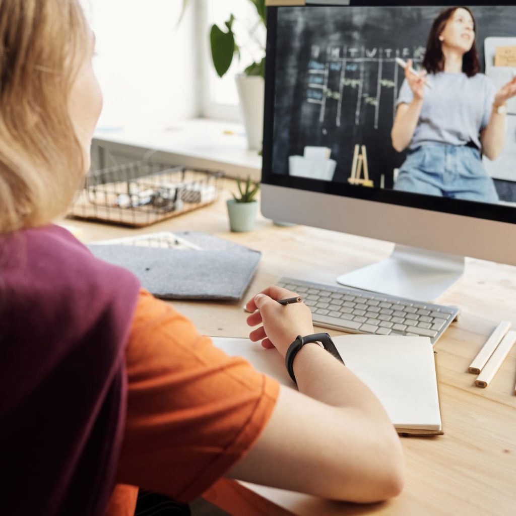 photo of girl watching through imac