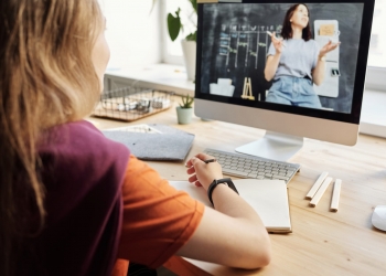 photo of girl watching through imac
