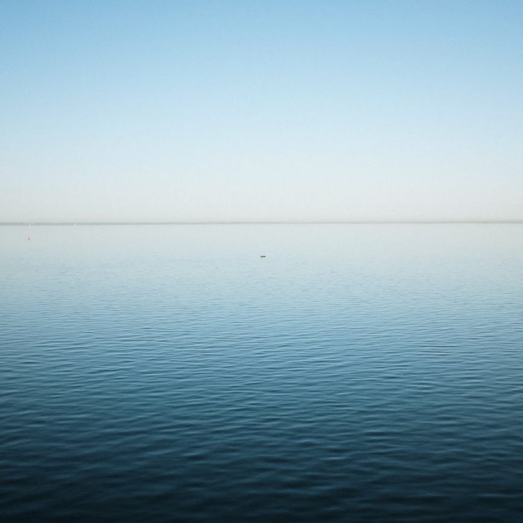 calm sea under blue sky