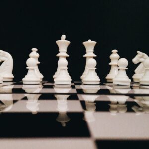 white chess piece on top of chess board