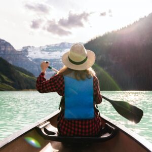 a woman paddling a boat in the lake