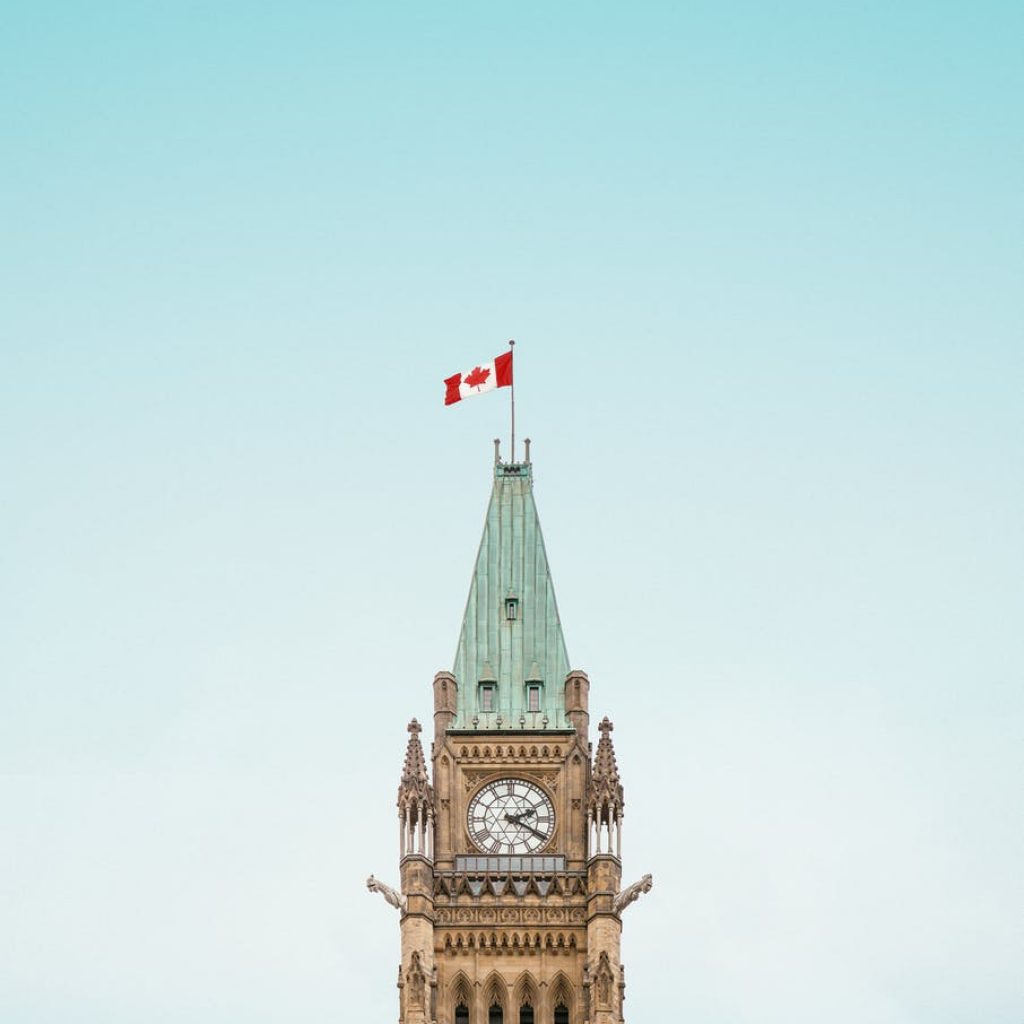 brown and white concrete building under blue sky