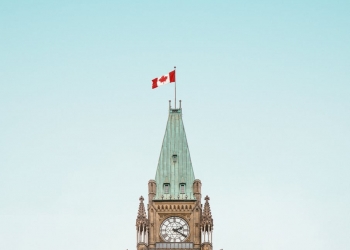 brown and white concrete building under blue sky
