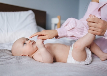 crop mother playing with baby