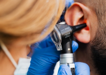 man in blue shirt holding black and silver microphone