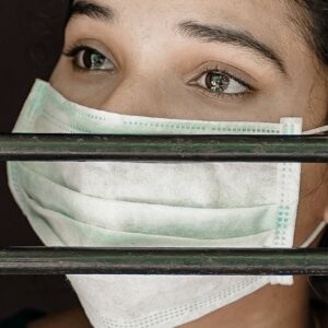 woman wearing face mask crying