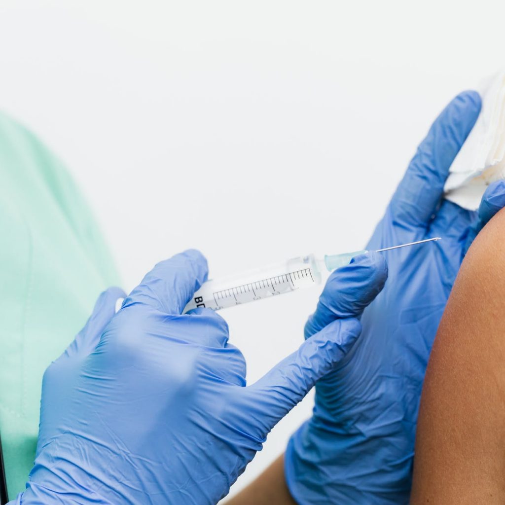 person in blue shorts lying on bed