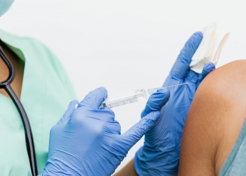 person in blue shorts lying on bed