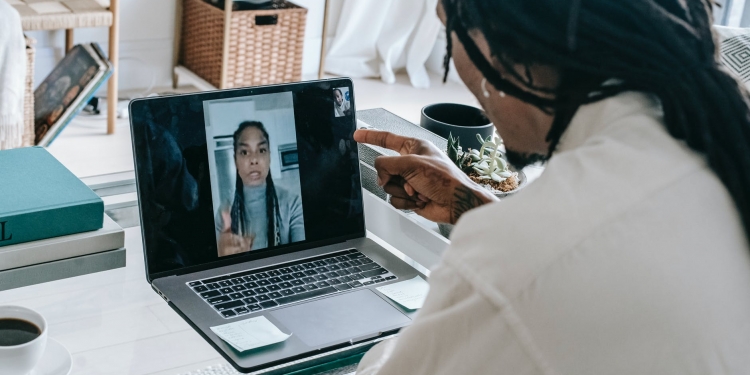 stressed black couple having video call via laptop
