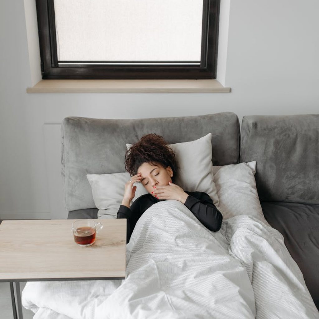 sick woman lying on the sofa