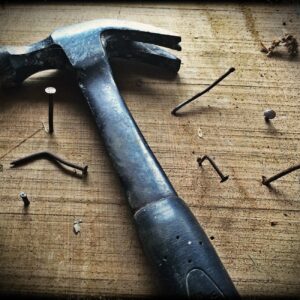 black claw hammer on brown wooden plank