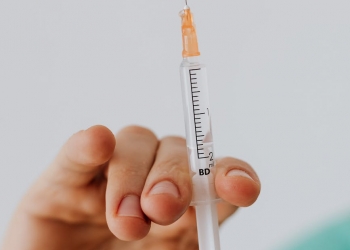 close up view of person holding a vaccine