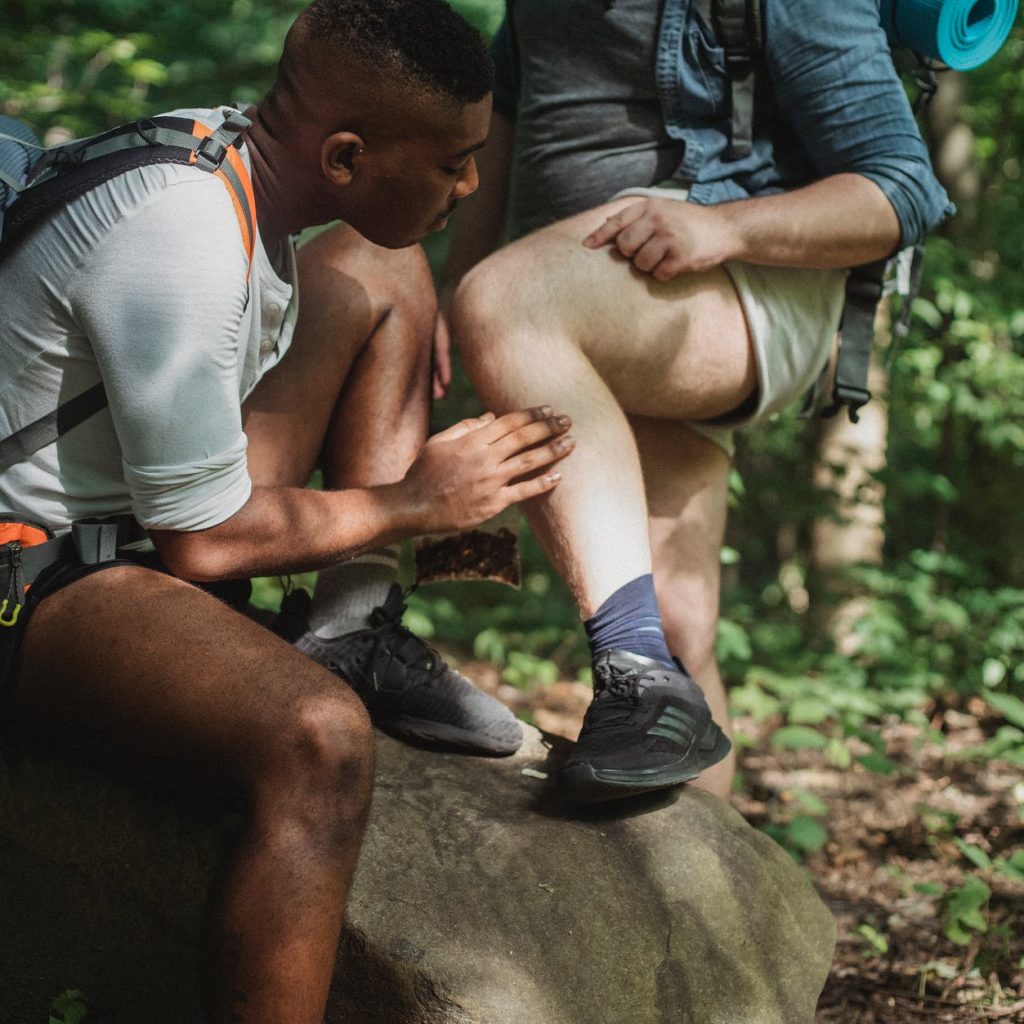 multiethnic friends searching for ticks while hiking