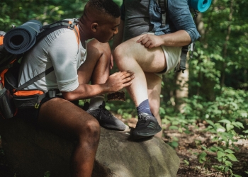 multiethnic friends searching for ticks while hiking