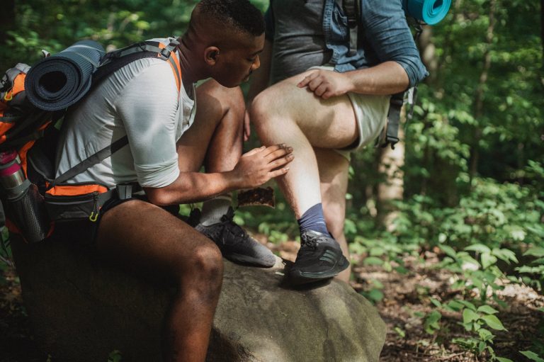 multiethnic friends searching for ticks while hiking