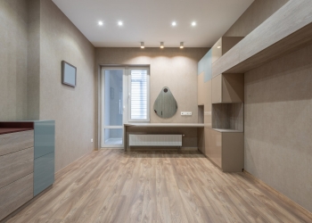 spacious room with cupboards and door