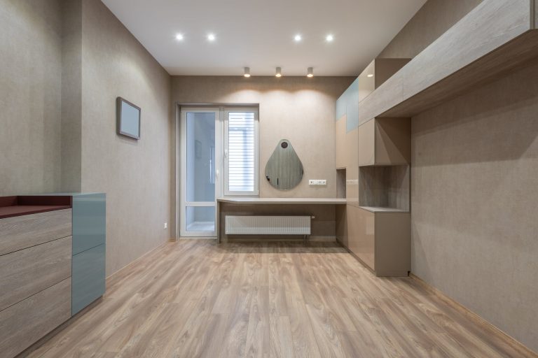spacious room with cupboards and door