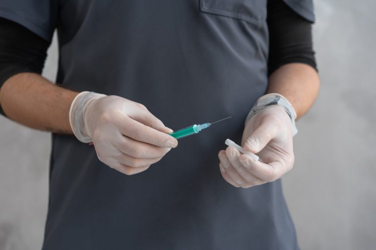 person in black shirt holding green and white pen