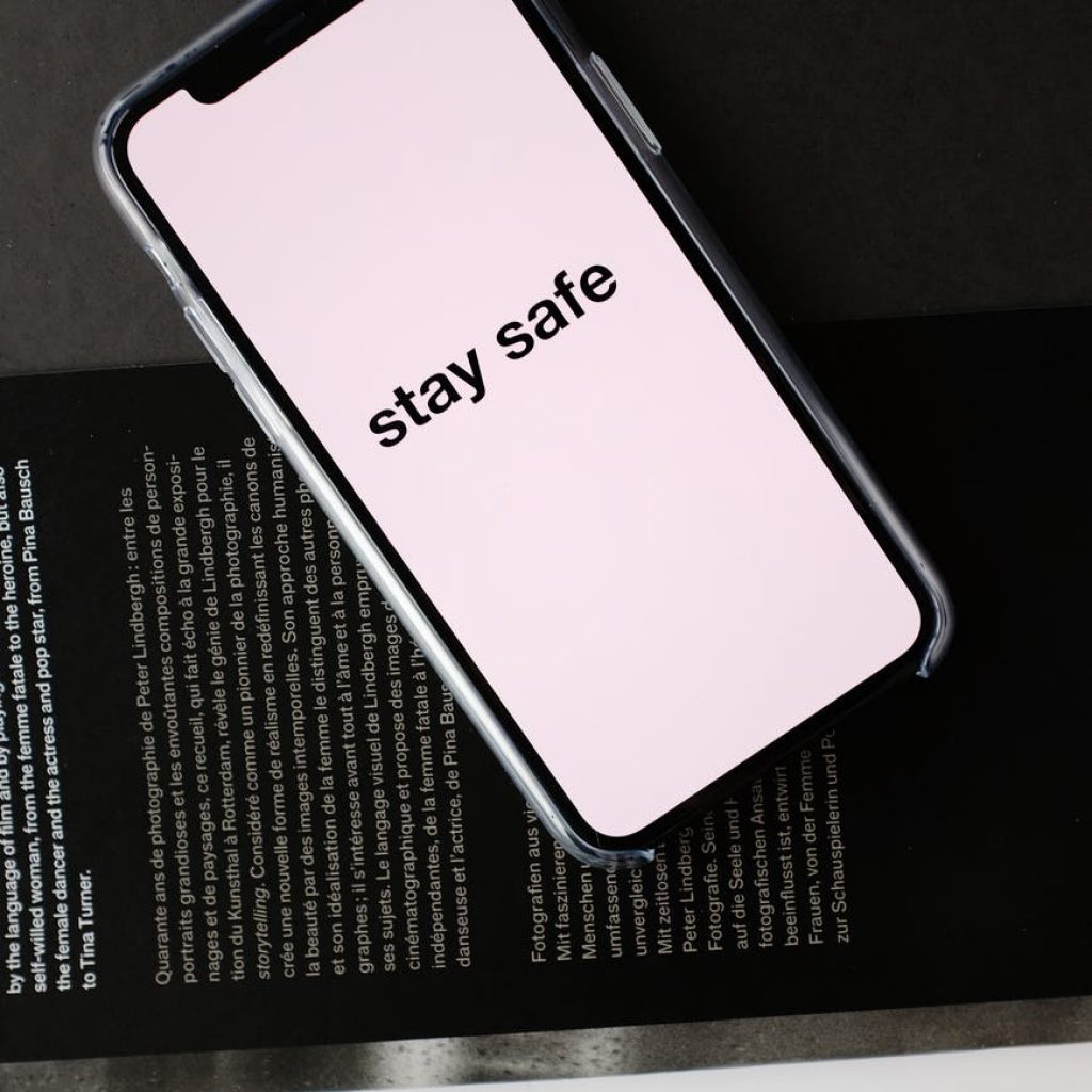 smartphone with stay safe title on open magazine