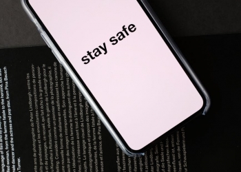 smartphone with stay safe title on open magazine
