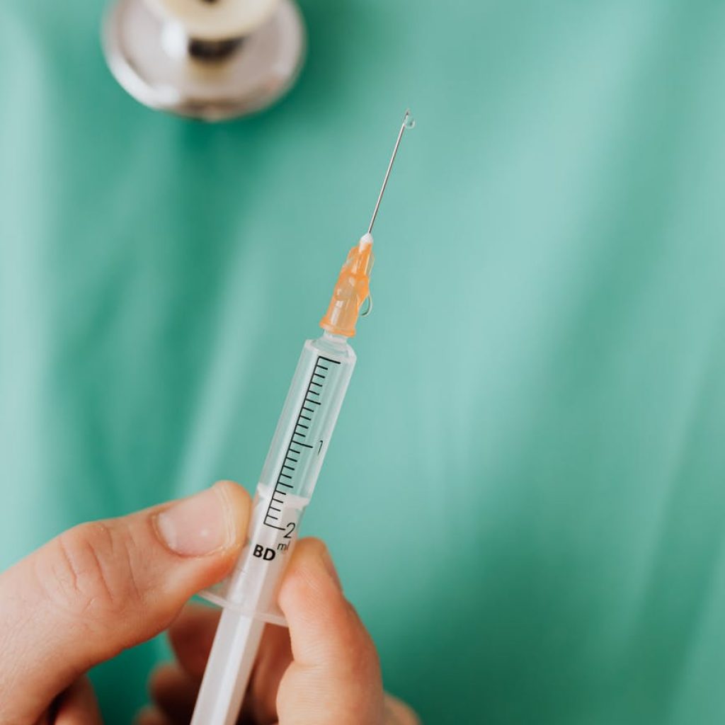 close up view of person holding a vaccine