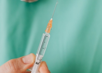 close up view of person holding a vaccine