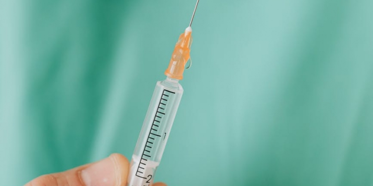 close up view of person holding a vaccine
