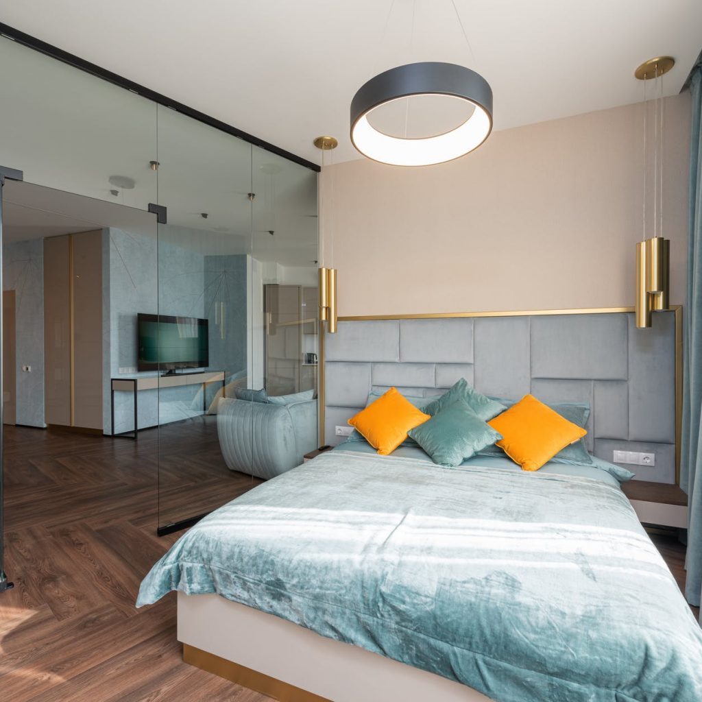 interior of spacious bedroom with comfy bed and modern design