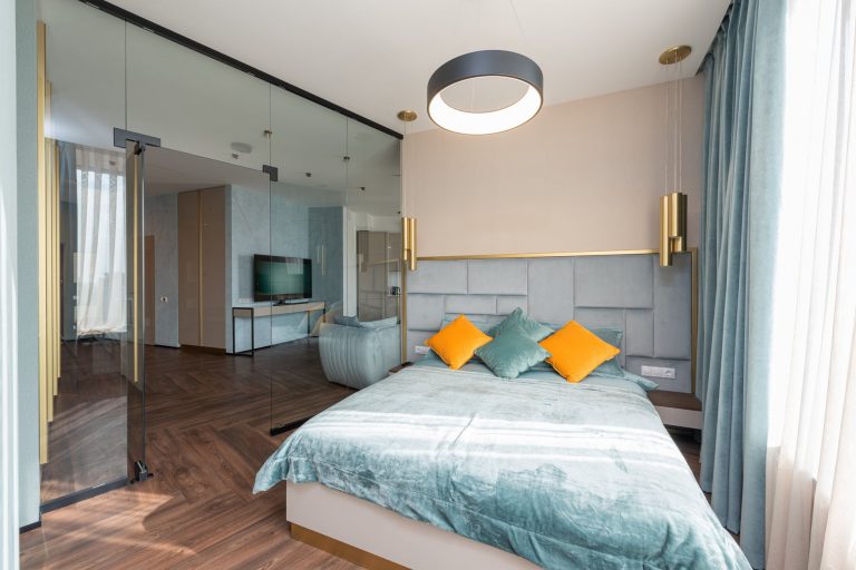 interior of spacious bedroom with comfy bed and modern design