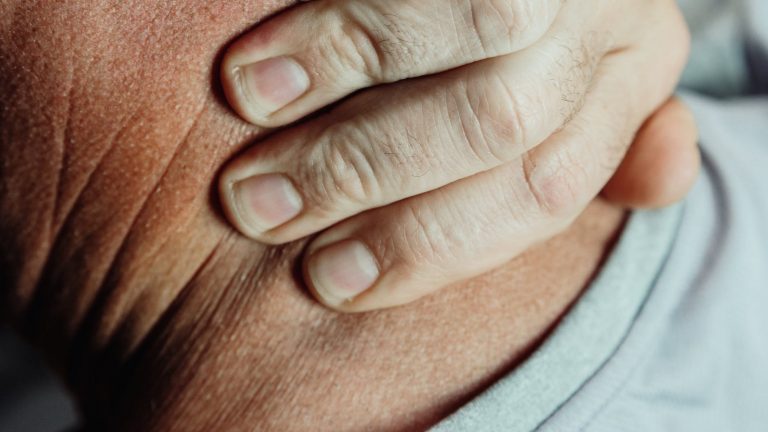 close up photo of a person having a neck pain
