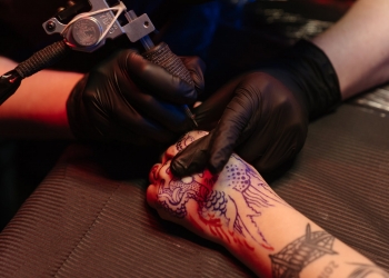 person with red rose tattoo on right arm